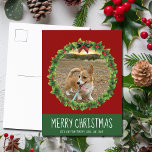Merry Christmas Wreath Cute Custom Dog Photo Red Postcard<br><div class="desc">Beautiful custom pet Christmas postcard featuring a green holiday wreath with a red background white text. Replace with your dog's photo in the centre of the wreath or add a cat picture for your friends and family. Merry Christmas is written in white.</div>