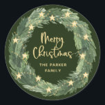 Merry Christmas Wreath with Gold Stars on Green Classic Round Sticker<br><div class="desc">These trendy and stylish Christmas stickers feature a pretty,  watercolor Christmas wreath with gold coloured star accents and lights,  with modern script calligraphy that says "Merry Christmas" on a forest green background.</div>