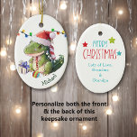 Merry Dinosaur Kids Christmas Ceramic Ornament<br><div class="desc">On the front of this keepsake ceramic ornament for a child is an adorable baby dinosaur wearing a Santa hat. He has a Christmas tree bulb between his feet, and a gift package beside him. There's a string of Holiday lights behind him. Your child's name is in dark green at...</div>