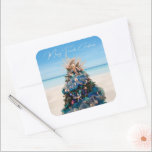 Merry Florida Christmas Tropical Beach and Tree Square Sticker<br><div class="desc">Celebrate the holidays with these gorgeous tropical-themed Christmas stickers. The design is a photo image of a stunning Christmas tree featured at the Orlando Museum of Art during the annual Festival of Trees exhibit. The beautiful holiday tree is adorned with coastal-inspired decorations including starfish, miniature mermaids, soothing pastel-coloured ornament balls...</div>