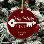 Merry Realtor New Home Key Custom Name Christmas Ceramic Ornament<br><div class="desc">This design features the text "Very Merry Realtor" with a cute house key and space for your text/name. Click the customise button for more flexibility in adjusting the image or adding your own text! Variations of this design, additional colours, as well as coordinating products are available in our shop, zazzle.com/store/doodlelulu....</div>