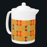 Mid Century Modern Orange Pattern Teapot<br><div class="desc">Knock, knock. Who's there? Mid Century Modern Orange Pattern Teapot! Hey, with a design this retro, you don't need a punch line. This perfectly mod pattern features a vibrant orange background and rows of an adorably kitschy shape in green, red, turquoise, black & white, and wood grain. The shape probably...</div>