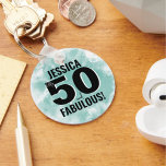 Milestone 50th Birthday Fabulous Key Ring<br><div class="desc">A blend of cute script and modern boldness with this simple "50 And Fabulous" design! Featuring a classic black and white colouring with a splash of colour from the teal blue (or light turquoise) watercolor background. Customise to the name, and if you need to, you can also change the 'and'...</div>
