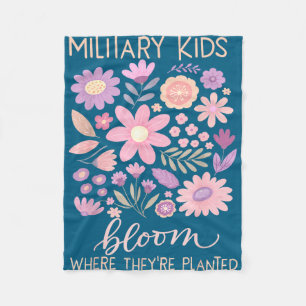 Military kid dandelion bloom where planted purple fleece blanket