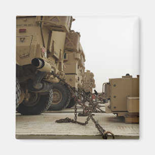 Military vehicles are locked down on semi truck magnet