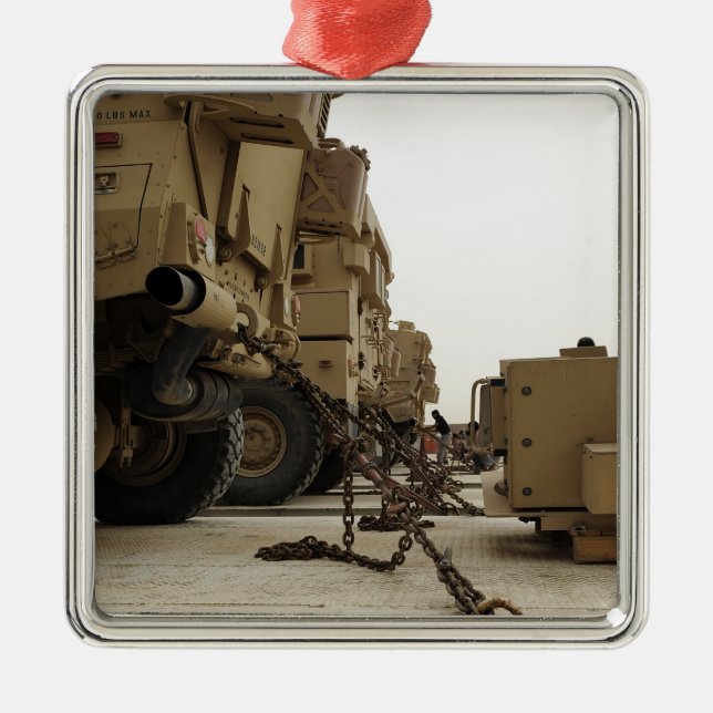 Military vehicles are locked down on semi truck metal tree decoration (Front)