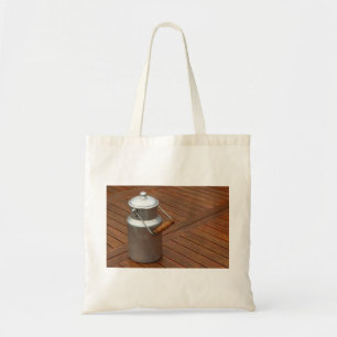 Milk can on a table tote bag