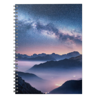 Milky Way over mountains in fog at night in summer Notebook
