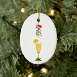 Mimosas and Mistletoe Christmas Ceramic Ornament<br><div class="desc">Mistletoe tied with a red ribbon hangs down over a mimosa glass to commemorate a special occasion on these Christmas ornaments. Great for a Christmas or holiday bridal shower brunch,  or a mimosas and mistletoe party! Available with matching products.</div>