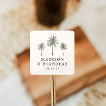 Minimal Palm Trees Personalised Wedding Square Sticker<br><div class="desc">Seal your wedding invitations and favours with these personalised palm tree stickers. The tropical wedding stickers feature three palm trees with your names and wedding date displayed below in black lettering on an ivory background. The palm tree wedding stickers were designed to coordinate with our Minimal Palm Tree wedding collection....</div>