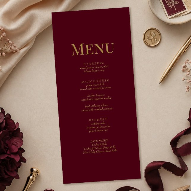 Minimalist Burgundy Gold Monogram Wedding Menu (Minimalist Burgundy Gold Monogram Wedding Menu on a table with gold and burgundy wedding decor)