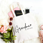 Minimalist Grandma EST 2025 Tote Bag | New Grandma<br><div class="desc">Celebrate the exciting journey to grandmotherhood with this chic and minimal “Grandma EST 2025” tote bag. Designed in modern script with a sweet heart detail, it's a stylish and functional gift for any newly promoted grandma. Whether it's for a pregnancy reveal, baby shower, or Mother’s Day — this durable tote...</div>