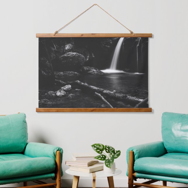 Minimalistic waterfall behind broken tree in black hanging tapestry (Living Room)