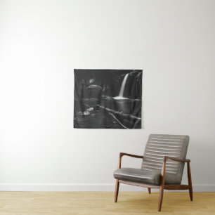 Minimalistic waterfall behind broken tree in black tapestry