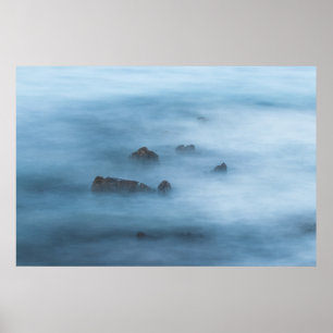 Misty blue long exposure of rocks in sea poster