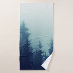Misty fog in pine forest on mountain slopes. Color Bath Towel