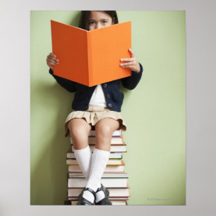 Mixed race girl sitting on stack of books poster