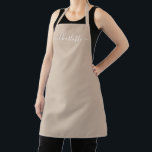 Modern beige tan custom script name solid plain apron<br><div class="desc">Personalised beige tan neutral custom modern script name text monogram solid plain colour girly stylish elegant chic beige tan neutral and white text kitchen Apron. Custom white text on solid plain beige background. Customise, personalise it with name, quote, phrase, or text. Great for cooks, chefs, pottery, ceramics, crafts, work, kitchen,...</div>