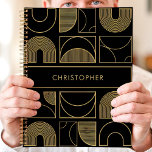 Modern Black and Gold Geometric Custom Name Planner<br><div class="desc">This modern planner design features a bold black background adorned with a sophisticated geometric pattern in radiant gold. The custom name showcased at the centre adds a sleek and personal touch to the overall design. Perfect for professionals, students, or anyone who values contemporary and luxurious aesthetics. Use it to organise...</div>