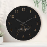 Modern Black Gold Feminine Script Monogrammed Large Clock<br><div class="desc">Modern Black Gold Feminine Script Monogrammed Large Clock. Easily personalize this modern elegant large clock with your custom monogram and name.</div>