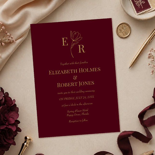 Modern Burgundy Floral Monogram Wedding Invitation (Modern Burgundy Floral Monogram Wedding Invitation on a table with burgundy and gold wedding decor)