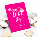Modern Christmas peace love joy script pink Holiday Card<br><div class="desc">Modern trendy casual typography Christmas peace love joy script with a little heart and Santa hat making a pretty Christmas holiday hot pink greeting card.             Personalise it with your family name and text on both sides!</div>