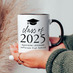 Modern Class of 2025 Black Script Graduation Cap Mug<br><div class="desc">Gift the grad a personalised graduation keepsake with this modern graduation coffee mug! The design features a black graduation cap at the top of the design with "Class of 2025" displayed in bold black lettering. Personalise the black and white graduation coffee mug with the graduate's name and school. The design...</div>