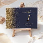 Modern Dark Blue Gold Glitter Edge Wedding Table Number<br><div class="desc">The left-hand edge of this elegant modern wedding table number features a gold faux glitter design. The customizable text combines pale gold colored handwriting,  copperplate and italic fonts on a dark blue background.</div>