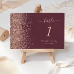 Modern Dark Burgundy Rose Gold Glitter Wedding Table Number<br><div class="desc">The left-hand edge of this elegant modern wedding table number features a rose gold faux glitter design. The customisable text combines pale rose-coloured handwriting,  copperplate and italic fonts on a dark burgundy background.</div>