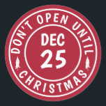 Modern Do NOT Open Until Christmas Stamp Classic Round Sticker<br><div class="desc">Stylish and fun, these stickers are the perfect accessory to your holiday gift-giving needs. The design features a solid red background with a white, round stamp with the text "Don't Open Until Christmas Eve" and the date "Dec 25." Great for packages, letters, and any other gifts you need to seal...</div>