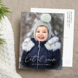 Modern Let it Snow Script Photo Holiday Postcard<br><div class="desc">Wish friends and family a Merry Christmas with a cute holiday photo postcard! The postcard features your vertical photo on the front with subtle snow flurries bordering the card. "Let it Snow" is displayed in a white, trendy calligraphy script with your family's name below. The simple holiday postcard reverses to...</div>