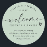 Modern Light Sage Green Wedding Welcome Hotel Bag Classic Round Sticker<br><div class="desc">Light Sage Hotel Bag Stickers: Soft and fresh, these light sage modern handwriting wedding welcome stickers bring a natural elegance to your wedding weekend. Each 3-inch round sticker features the phrase “welcome friends & family” with a small heart accent and space for your short message. The couple’s names and wedding...</div>