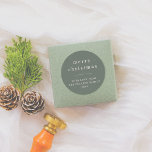 Modern & Minimal Merry Christmas Family Name Green Classic Round Sticker<br><div class="desc">A minimalist Christmas sticker design featuring a dark green background and white typography. The sticker starts with "merry christmas" or the greeting of your choice, followed by your family name and the year. There is a horizontal line divider separating the two sections. Ideal for sealing envelopes, decorating gift boxes, or...</div>