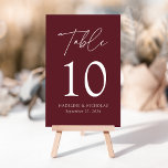 Modern Minimalist Merlot Wedding Table Number<br><div class="desc">Elegant wedding table number card displaying the word "Table" in a white handwritten script with the table number, your names, and wedding date shown below with a merlot-coloured background. The design repeats on the back. To order the table number cards, simply type each number and add it to your cart....</div>