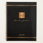 Modern monogrammed black gold elegant name script planner<br><div class="desc">Luxury exclusive looking monogrammed stylish personalised planner featuring a faux gold copper metallic glitter square and lines over a stylish classy black leather look background.           Personalise it with your text,  your name and monogram initials.</div>