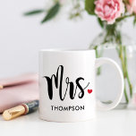Modern Mrs Calligraphy Heart Monogram Coffee Mug<br><div class="desc">This beautiful Mrs mug features bold brush calligraphy with a sweet red heart accent and a custom last name in spaced uppercase lettering beneath. The oversized script on a crisp white background delivers a modern, minimalist wedding aesthetic. The last name is fully editable for a personalised keepsake. A lovely gift...</div>