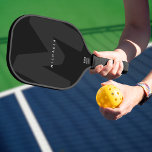 Modern Oversized Monogrammed Initial & Name Pickleball Paddle<br><div class="desc">Elevate your game with this personalised pickleball paddle featuring a sleek, modern design. The large, dark grey initial on a black background creates a bold backdrop, complemented by your name in white minimalist typography for a custom and professional look. The clean aesthetic and black, white or tan trim make this...</div>