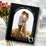 Modern Photo Arch Black Wedding Planner<br><div class="desc">An elegant spiral-bound planner with 60 pages and 12 months, features a single vertical or portrait-orientated wedding photo in a unique arched layout. CHOOSE SOFT OR HARD COVER. Your names are joined with a large white ampersand at the bottom and your wedding date arched at the top. Change the colour...</div>
