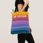 Modern Rainbow Stripes Teacher Name Gift Tote Bag<br><div class="desc">This tote bag features bold, cheerful horizontal stripes in a full rainbow gradient — from warm yellows and oranges through coral, pink, purple, and teal — with a personalized name printed in clean white lettering across the front. The bright, modern design makes it a fun and practical gift any teacher...</div>