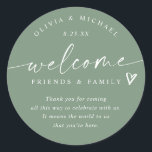 Modern Sage Green Wedding Welcome Hotel Bag Classic Round Sticker<br><div class="desc">Sage Green Hotel Bag Stickers: Welcome guests to your wedding weekend with these elegant sage green modern handwriting hotel bag stickers — a stylish finishing touch for your welcome gifts. Each 3-inch round sticker features the phrase “welcome friends & family” with a small heart accent above your short message. The...</div>