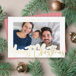 Modern Script Merriest Christmas Photo Gold Foil Holiday Card<br><div class="desc">This modern holiday photo card features a calligraphy script greeting in raised gold foil over a white background with a single horizontal photo. The back has a simple yet festive red and white diagonal stripe pattern which can removed if desired. This modern design works well with many different photos. Add...</div>