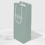 Modern Script Personalised Bridesmaids Wine Gift Bag<br><div class="desc">Personalised Bridesmaids Gift Bag featuring personalised bridesmaid's name in white modern script font style and monogram in sage green modern script font style as background with title and wedding date in white modern sans serif font style on sage green background. Also perfect for maid of honour, flower girl, mother of...</div>