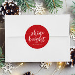 Modern Shine Bright Script Red Holiday Classic Round Sticker<br><div class="desc">Add a festive touch to your holiday envelopes and gift boxes with our Shine Bright holiday stickers. The custom holiday stickers feature the words "Shine Bright" in a white, modern hand-lettered script and a red background. Personalise the stickers by adding your name or custom text below.</div>