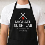 Modern Sushi Lab Name with Crossed Chopsticks Apron<br><div class="desc">This design features a sleek culinary logo with crossed chopsticks, a bold red sushi-inspired icon, and clean white typography on a dramatic black background. The “Michael Sushi Lab” name is paired with the tagline “Mastering the Art of Rollcraft, ” giving it a refined, chef-driven identity. Its minimalist layout and high-contrast...</div>