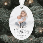 Modern Trendy Script Merry Christmas 2 Photos Oval Ornament<br><div class="desc">Celebrate the simple joys of the holidays with a custom Merry Christmas two photo acrylic oval ornament. The pictures and all wording on this template are easy to personalise and can be different or the same on front and back. The modern minimalist black and white design features trendy script calligraphy,...</div>