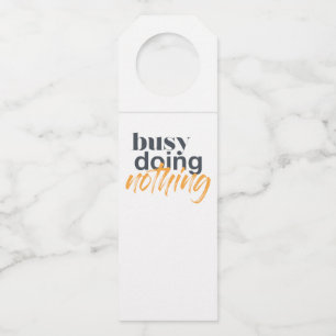 Modern, trendy, urban design of Busy Doing Nothing Bottle Tag