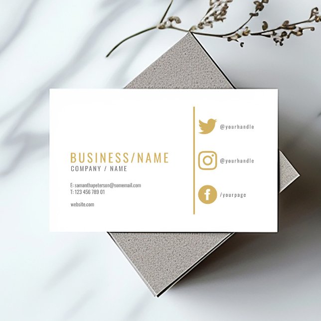 Modern white social media gold icons business card (Modern gold and white business card with social media icons and minimalist layout.)