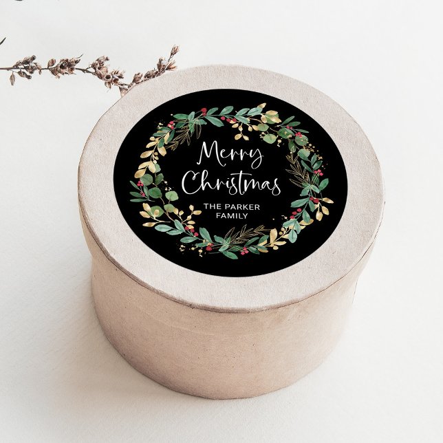 Modern Wreath and Script | Merry Christmas Classic Round Sticker (An elegant Christmas sticker with green and gold leaves and red berries)