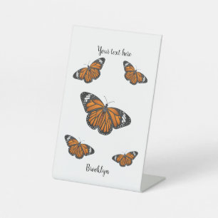 Monarch butterfly cartoon illustration pedestal sign