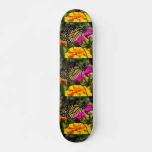 Monarch butterfly on pink marigold-skateboard skateboard